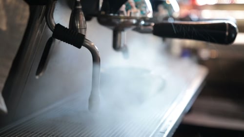 Close Up of Espresso Machine Steaming Milk