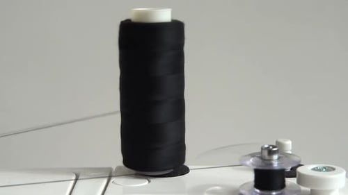 Black Thread Spool on Sewing Machine Close Up