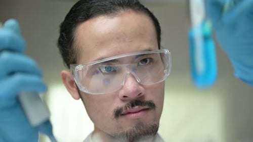 Scientist Analyzes Test Tube in Laboratory Setting