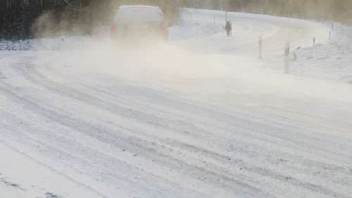 Cars Move Along The Snow-covered Road