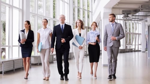 Business People Walking Along Office Building 1
