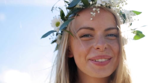 Smiling Woman with Flower Crown in Sunlight