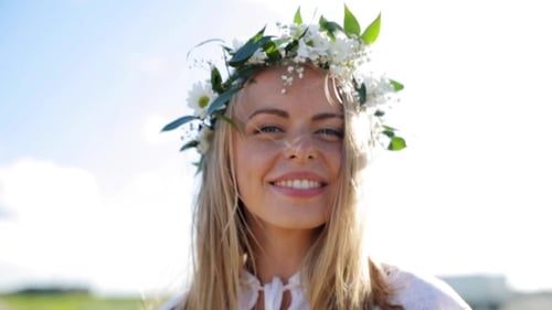 Woman with Floral Crown Smiling in Sunlight