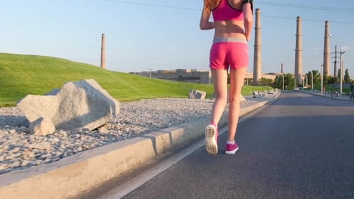 Sport Footage, Detail Legs Of Woman Running On Empty Street Beside Cornfields