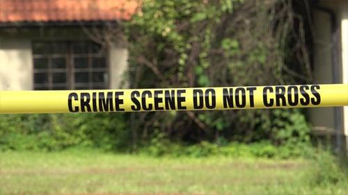 Crime Scene Tape Blocking Entrance to Building