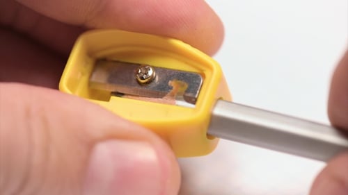 Man Sharpening a Pencil