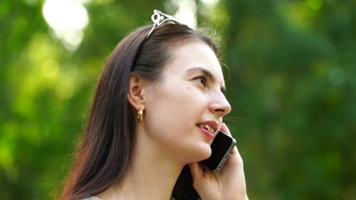 Woman Talking on Phone Outdoors Smiling