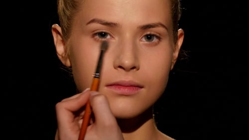 Woman Receiving Eye Makeup Application in Close-Up