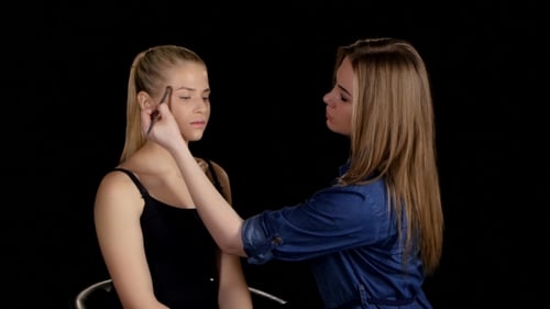 Applying Highlighter. Professional Make-up Artist. Makeup