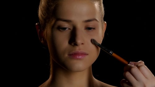 Woman Styling Eye Brows with Makeup Brush