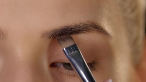 Beautiful Woman Draw Beauty Shape Of Eyebrows Using Cosmetic Brush. Black.