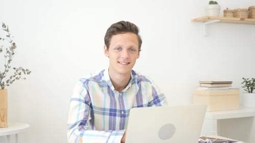 Smiling Young Adult Looks into Camera