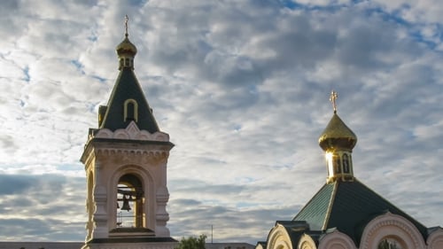 Church With Gold Domes Against The Sky And Moving Clouds