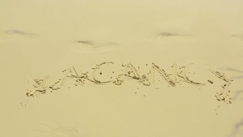 Writing Vacation in Sand as Wave Washes it Away