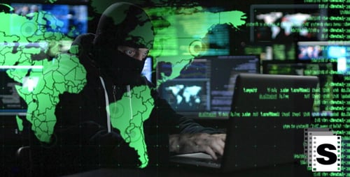 Hacker Typing on Laptop Keyboard in Dark Room