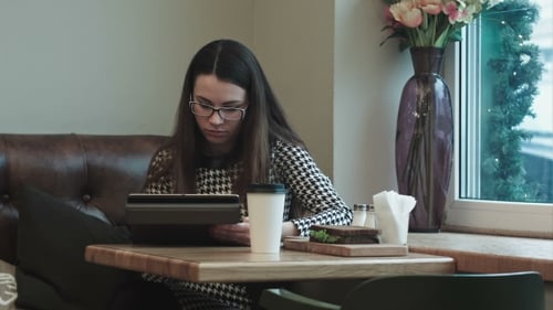 Business Woman On Lunch Break With Tablet In Cafe Or Restaurant Working