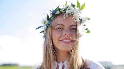 Woman Wearing Flower Crown Smiling in Sunlight