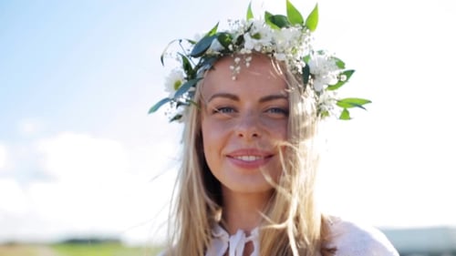 Smiling Woman with Flower Crown in Sunny Field