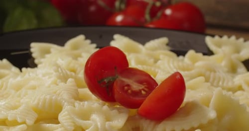 Pasta Dish with Cherry Tomatoes Falling in Slow Motion