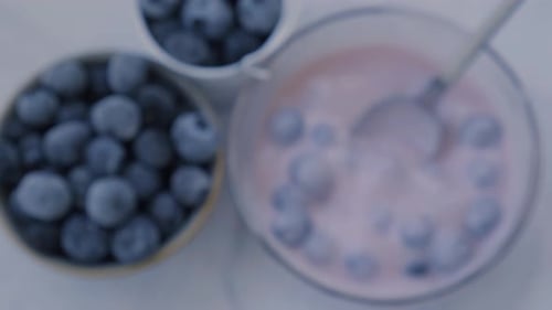 Bowl with Yogurt and Blueberries on Table