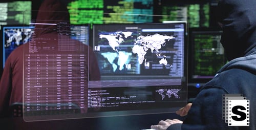 Hackers Working at Computers in Dark Room