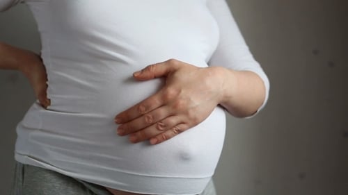 Pregnant Woman Holding Her Abdomen Close Up