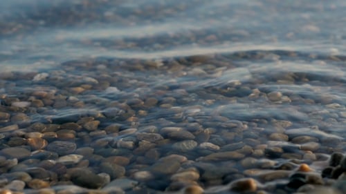 Sea Braking Against Stones And Pebbles On a Beach, Waves Of Pure Water