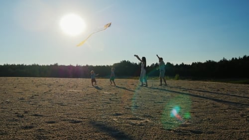 Family Kite Flying in Rural Area During Daytime