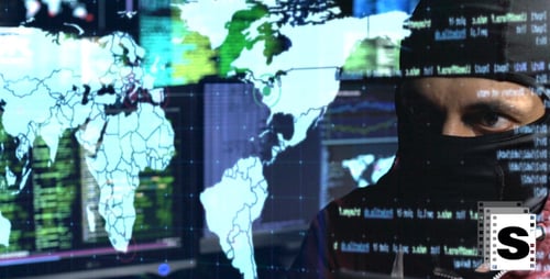 Masked Hacker Working in Front of Multiple Monitors