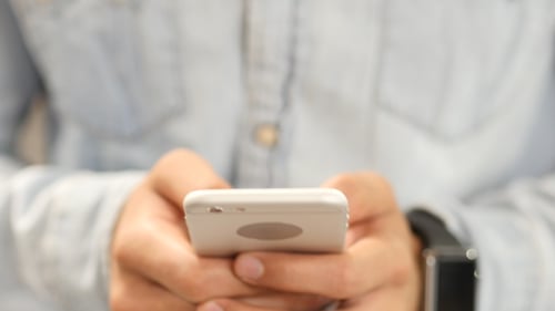 Man's hands using mobile phone and smart watch
