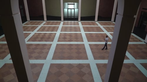 Adult Walking Alone Across Large Room