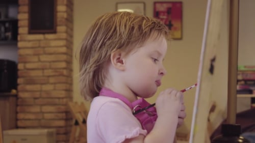 Child Painting on Canvas in Home Art Studio