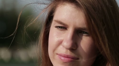 Attractive Woman Smiling Outdoors in the Wind