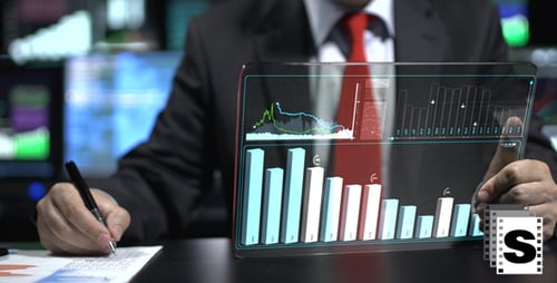 Adult Works on Transparent Tablet with Financial Data