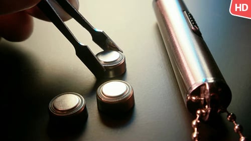 Close Up of Batteries and Mini Flashlight