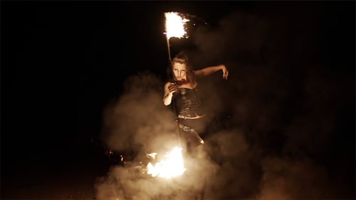 Woman Performs Fire Dance at Night