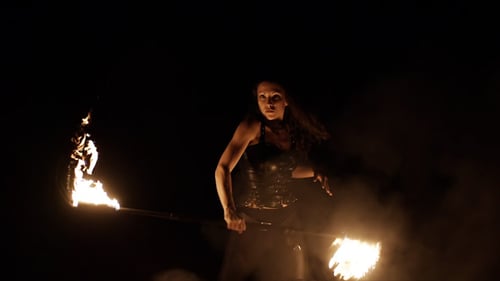 Woman Performing Fire Dance with a Staff