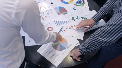 Business Colleagues Collaborate Over Data and Graphs