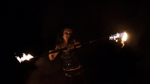 Woman Performs Fire Dance at Night