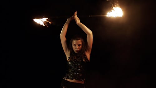 Woman Performs Mesmerizing Fire Dance in Dark Studio