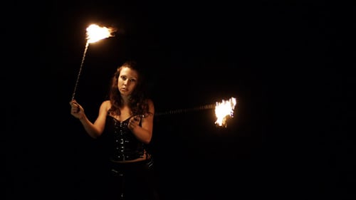 Woman Performs Fire Dance with Glowing Batons at Night