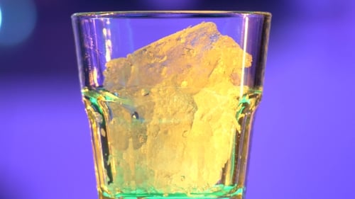 Preparing a Refreshing Orange Beverage with Ice