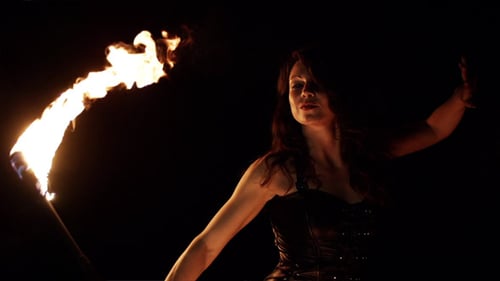 Woman Performing Fire Art at Night