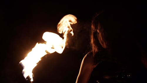 Woman Performs Fire Dance at Night