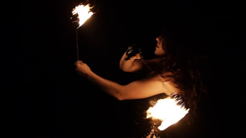 Woman Performing Dramatic Fire Staff Arts at Night