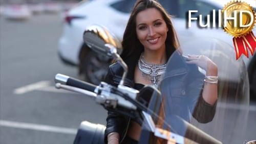 Stylish Woman Poses on Motorcycle in Urban Setting