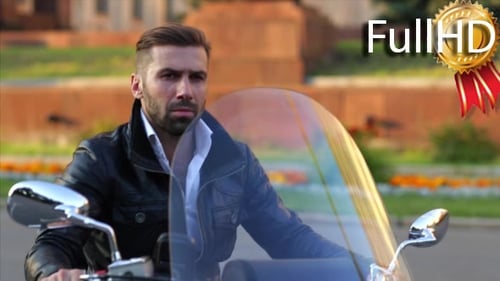 Man Sits on Motorcycle in the City