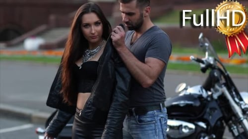 Man Puts Jacket on Woman Near Motorcycle