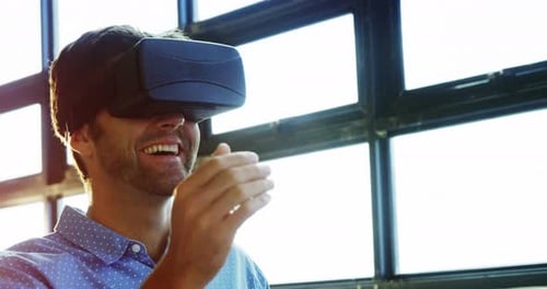 Young Adult Using Virtual Reality Headset in Bright Office