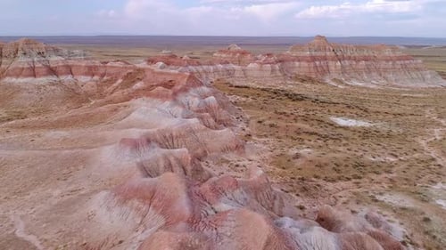 Flying over red desert ridge and hills in the mars like desert